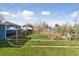 A large backyard with green grass and patio, providing ample room for outdoor activities and relaxation at 4040 Ames St, Wheat Ridge, CO 80212