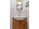 Bathroom vanity with a white countertop sink and traditional wood cabinet at 4040 Ames St, Wheat Ridge, CO 80212