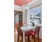 Charming dining area with a vintage cabinet and sun-drenched windows at 4040 Ames St, Wheat Ridge, CO 80212