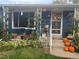A charming front porch welcomes visitors with seasonal decorations and cozy seating at 4040 Ames St, Wheat Ridge, CO 80212