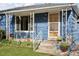 Inviting covered porch with decorative ironwork, providing a pleasant spot to relax at 4040 Ames St, Wheat Ridge, CO 80212