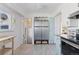 This kitchen boasts tiled floors, stainless appliances, and access to outdoor light and air at 4040 Ames St, Wheat Ridge, CO 80212