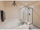 Bright bathroom offers a separate tub and shower, neutral colors, and chandelier lighting at 6916 Crestop Pl # F, Parker, CO 80138