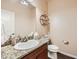 Well-maintained bathroom featuring granite countertops and modern fixtures at 6916 Crestop Pl # F, Parker, CO 80138