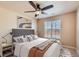 Stylish bedroom with ceiling fan, and a large window for natural light at 6916 Crestop Pl # F, Parker, CO 80138