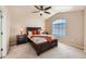 Comfortable bedroom features a ceiling fan, large window, neutral color palette and plenty of natural light at 6916 Crestop Pl # F, Parker, CO 80138