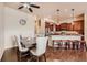 Dining room next to kitchen featuring wood floors and a modern dining set, with ample natural light at 6916 Crestop Pl # F, Parker, CO 80138