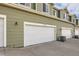 Exterior view of multiple garage doors on a row of townhomes, each with an address at 6916 Crestop Pl # F, Parker, CO 80138