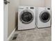 Laundry room features tile floors and modern washer and dryer at 6916 Crestop Pl # F, Parker, CO 80138