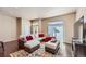 Bright living room featuring an oversized sectional sofa, plush rug, and natural light at 6916 Crestop Pl # F, Parker, CO 80138