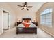 Main bedroom with a large window, ceiling fan, and bedside tables with lamps at 6916 Crestop Pl # F, Parker, CO 80138