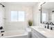 Elegant bathroom featuring marble tile, a tub, and modern fixtures, creating a spa-like experience at 12050 Dahlia Dr, Thornton, CO 80241
