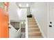 Inviting entryway with hardwood floors, bright lighting, and a staircase leading to the upper level at 12050 Dahlia Dr, Thornton, CO 80241