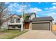 Well-maintained two-story home with a stone facade, updated garage door, and a cozy front yard at 12050 Dahlia Dr, Thornton, CO 80241