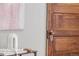 Close-up of a bedroom door with vintage hardware and an adjacent decorative tabletop at 2427 W Argyle Pl, Denver, CO 80211