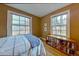 Bedroom with two large windows providing ample natural light and a wooden bookshelf at 1610 Locust St, Denver, CO 80220