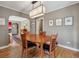 Inviting dining room with hardwood floors, modern light fixture, and access to other living spaces at 1610 Locust St, Denver, CO 80220