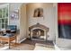 Close up of the living room fireplace with brick surround and inset shelving at 1610 Locust St, Denver, CO 80220