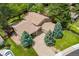 Aerial view of the house showing the roof, driveway, landscaping and overall property layout in a green neighborhood at 6407 S Heritage W Pl, Centennial, CO 80111