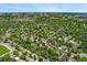Aerial view showing property location in a neighborhood with plenty of lush green trees and buildings in the distance at 6407 S Heritage W Pl, Centennial, CO 80111