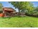Expansive backyard with lush lawn, mature trees, and a multi-level deck perfect for outdoor entertaining at 6407 S Heritage W Pl, Centennial, CO 80111