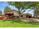 Expansive backyard with a lush lawn, shade trees, and a charming wooden deck for outdoor entertaining and relaxation at 6407 S Heritage W Pl, Centennial, CO 80111