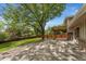 Landscaped backyard with a well-maintained lawn, mature trees, and a patio area for outdoor entertaining at 6407 S Heritage W Pl, Centennial, CO 80111