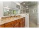 Renovated bathroom featuring a granite vanity, walk-in shower, updated fixtures, and a modern design at 6407 S Heritage W Pl, Centennial, CO 80111