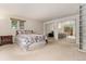 Bright bedroom featuring a large window, a full closet, and neutral carpet for an inviting living space at 6407 S Heritage W Pl, Centennial, CO 80111