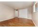 Large primary bedroom showcasing gorgeous hardwood flooring and closet space at 6407 S Heritage W Pl, Centennial, CO 80111