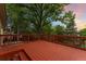 Exterior deck surrounded by mature trees, offering a tranquil outdoor space for unwinding and enjoying the scenery at 6407 S Heritage W Pl, Centennial, CO 80111