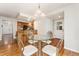 Dining area features a glass topped table and seamlessly adjoins the kitchen area in the home at 6407 S Heritage W Pl, Centennial, CO 80111