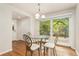 Bright dining area features a glass topped table, four chairs, and a sliding glass door to the back yard at 6407 S Heritage W Pl, Centennial, CO 80111