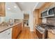Modern kitchen featuring wood cabinets and granite countertops at 6407 S Heritage W Pl, Centennial, CO 80111