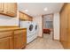 Well-lit laundry room with updated appliances and cabinetry at 6407 S Heritage W Pl, Centennial, CO 80111