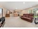 Spacious lower-level living room with wet bar, plush sofa, and walkout access to the yard at 6407 S Heritage W Pl, Centennial, CO 80111