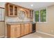 Functional wet bar features a granite countertop, glass cabinets, and a built-in refrigerator at 6407 S Heritage W Pl, Centennial, CO 80111