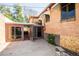 Backyard with glass-enclosed patio and brick wall shows some visible water damage at 1195 Boston St, Aurora, CO 80010