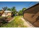 Backyard with shed, brick wall, and overgrown grass offers potential for customization at 1195 Boston St, Aurora, CO 80010