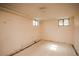 Unfinished basement with visible pipes, two windows, and concrete floor offers potential for customization at 1195 Boston St, Aurora, CO 80010