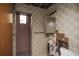 Bathroom with tiled shower, a mirror, and exposed wall areas shows some visible water damage at 1195 Boston St, Aurora, CO 80010