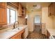 Kitchen showcasing cabinetry, and natural light; ideal space to renovate into a chef's dream at 1195 Boston St, Aurora, CO 80010