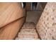 Stairway leading to the basement with patterned carpet at 1195 Boston St, Aurora, CO 80010