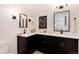 This bathroom boasts dual sinks with a contemporary vanity, mirrors, and stylish black accents at 2136 S Josephine St, Denver, CO 80210