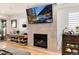 Cozy living room featuring a fireplace, entertainment center, and comfortable seating, perfect for relaxation at 2136 S Josephine St, Denver, CO 80210