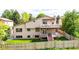 Spacious backyard featuring a two-story deck, fenced yard, and lush green grass for outdoor enjoyment and privacy at 11241 E Cimmarron Dr, Englewood, CO 80111