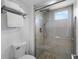 Clean bathroom featuring a glass-enclosed shower with stone tile flooring at 11241 E Cimmarron Dr, Englewood, CO 80111