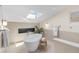 Bright bathroom featuring a skylight, a soaking tub, and a decorative fireplace at 11241 E Cimmarron Dr, Englewood, CO 80111