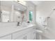Modern bathroom featuring a large mirror, a well-lit vanity, and neutral-toned walls at 11241 E Cimmarron Dr, Englewood, CO 80111