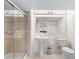 Clean and bright bathroom featuring a tiled shower, pedestal sink, and modern fixtures for a functional space at 11241 E Cimmarron Dr, Englewood, CO 80111